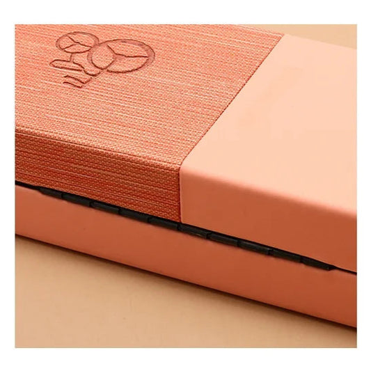 Close-up of a peach-colored fabric with a subtle pattern on a beige background