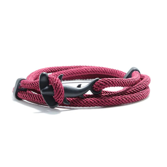 A red Shark Tide bracelet with a black fastener, designed to represent the strength and movement of ocean waves.