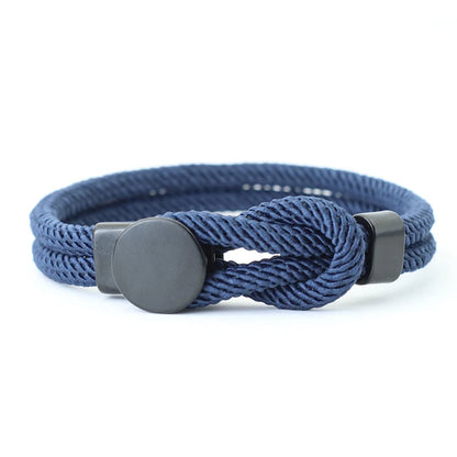A red bracelet with a knot design and a black fastening mechanism, presented against a white background.
