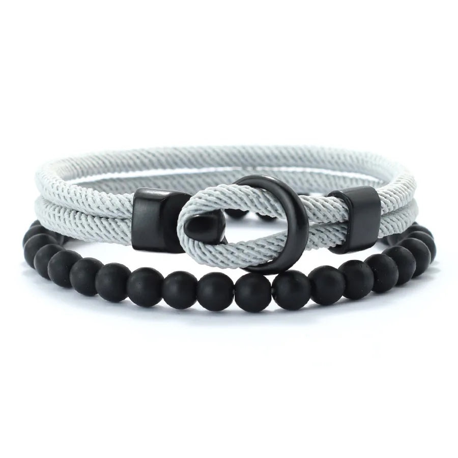 Two bracelets with a rope design and black beads on a white background