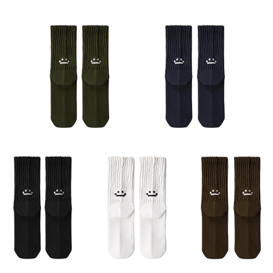 Set of six pairs of socks in green, black, white, and brown on a light gray background.