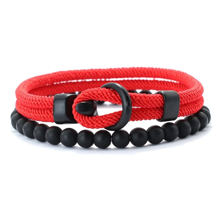 Red braided bracelet with black beads and a black clasp on a white background