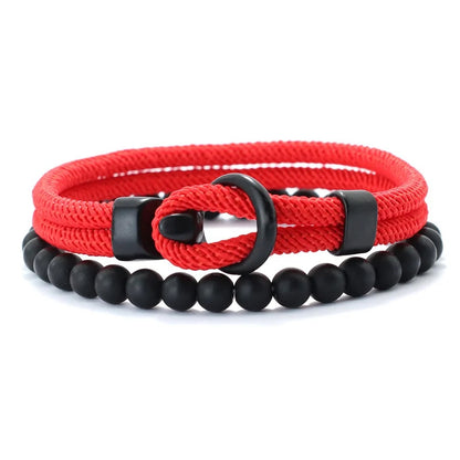 Red braided bracelet with black beads and a black clasp on a white background