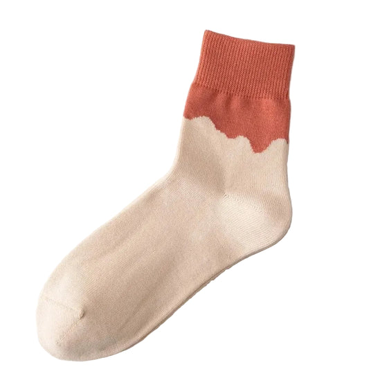 Beige sock with terracotta-colored top on a light gray background