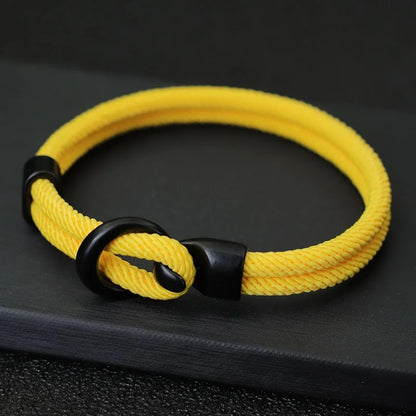 Yellow bracelet with black clasp on a dark background