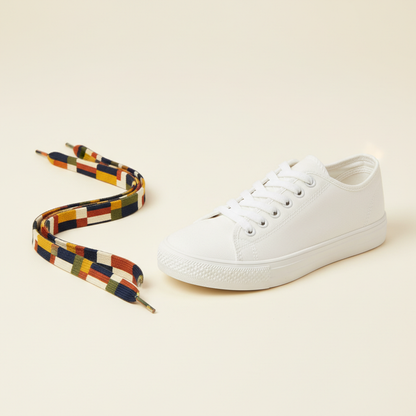 Printed flat shoelaces with abstract geometric pattern beside a white sneaker